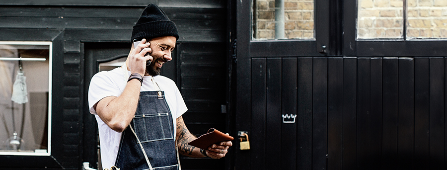 Image of a small business owner accepting a payment with a business debit card.