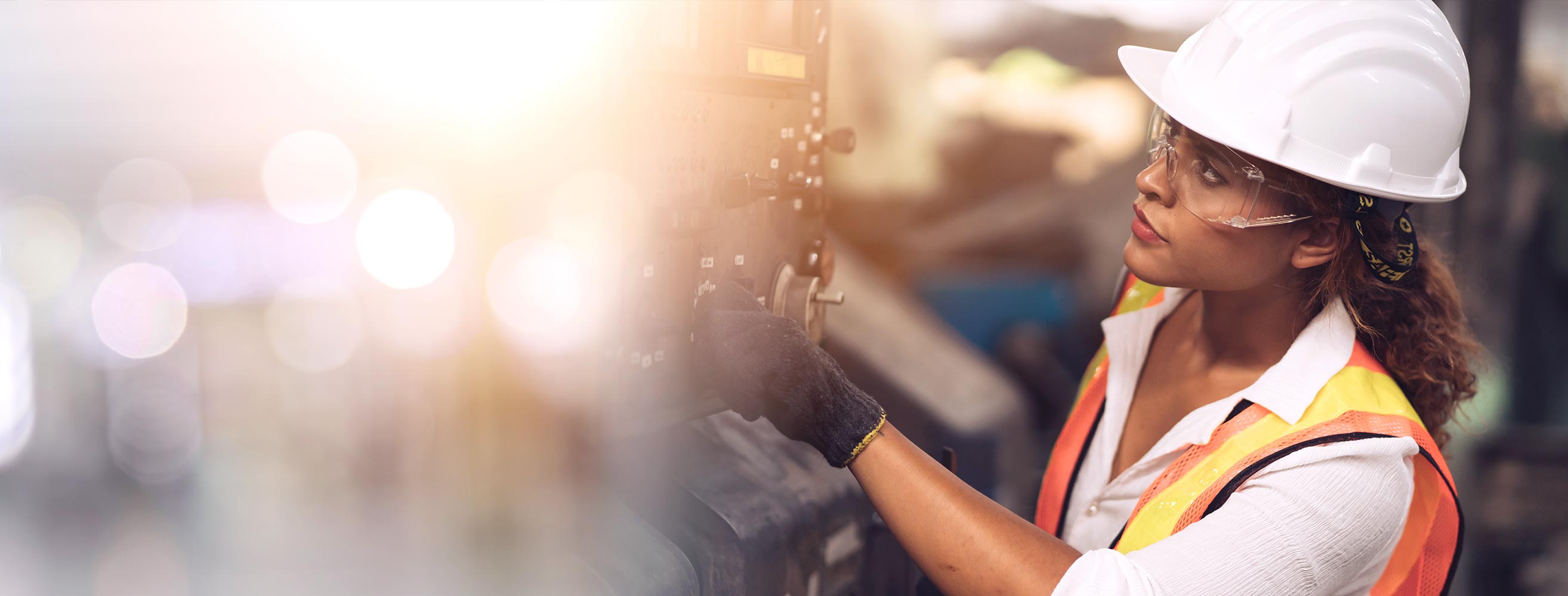 Proudly inspecting the factory floor, her hard hat gleams.