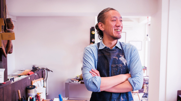 Portrait of a craftsman wearing an apron looking away from the camera. Kyoto, Japan. May 2016