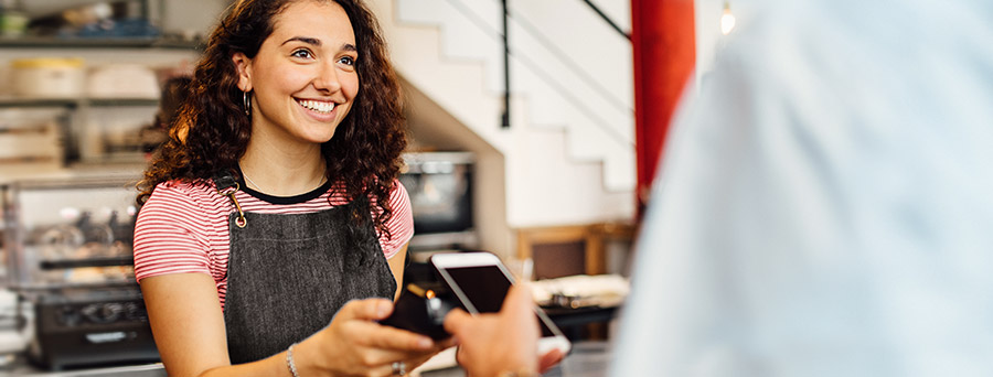 Image of a small business owner reviewing EFTPOS machine costs and fees.