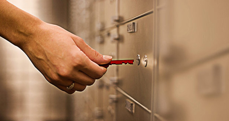  hand unlocking the deposit box of a deceased estate