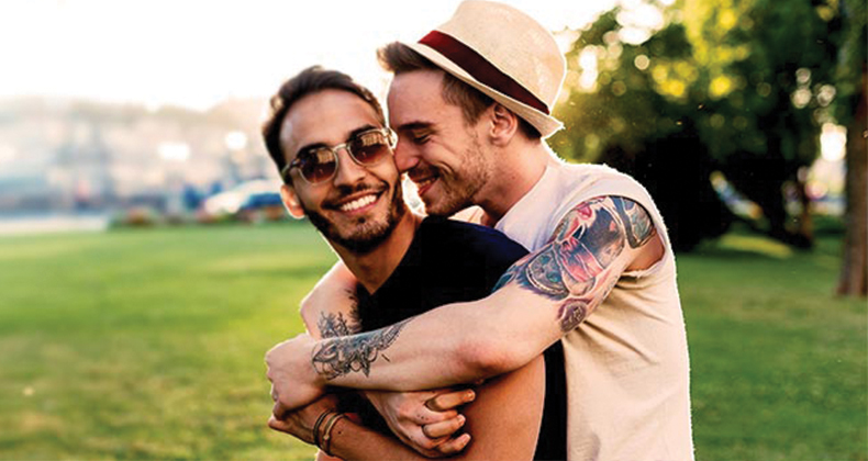 Engaged couple embracing each other in the park