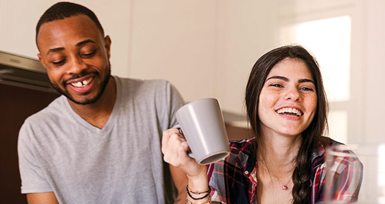 recently married couple laughing in the living room